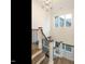 Elegant foyer staircase with iron railings and wood steps, illuminated by a modern chandelier at 213 Big Bradley Dr, Wendell, NC 27591