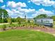 Community entrance sign with manicured landscaping and a glimpse of the homes beyond at 235 Augusta Pond Way # 161, Raleigh, NC 27603