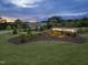 Entrance to Georgia's Landing with manicured lawn and shrubbery at dusk at 235 Augusta Pond Way # 161, Raleigh, NC 27603