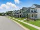 Street view of new two-story homes featuring landscaped front yards and inviting entryways at 235 Augusta Pond Way # 161, Raleigh, NC 27603