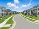 Street view of new two-story homes with sidewalks and green lawns under a cloudy blue sky at 235 Augusta Pond Way # 161, Raleigh, NC 27603