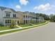View of new construction homes along a tree-lined street with sidewalks and landscaped yards at 235 Augusta Pond Way # 161, Raleigh, NC 27603