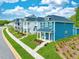 Colorful new construction homes along a landscaped street with sidewalks at 235 Augusta Pond Way # 161, Raleigh, NC 27603