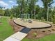Outdoor exercise area with equipment surrounded by trees and grass at 235 Augusta Pond Way # 161, Raleigh, NC 27603