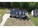 Aerial view of a home with a well-maintained yard and driveway and fenced backyard at 2570 Sweet Bay Rd, Rocky Mount, NC 27804