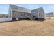 Wide backyard showcasing the house's back exterior, a deck, and a partially fenced yard at 2570 Sweet Bay Rd, Rocky Mount, NC 27804