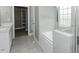 Bathroom with double vanity, separate tub and glass shower, and walk-in closet at 2570 Sweet Bay Rd, Rocky Mount, NC 27804