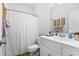 This bright bathroom has a white vanity, sink, toilet, and shower with a white shower curtain at 2570 Sweet Bay Rd, Rocky Mount, NC 27804