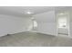 A carpeted bedroom with multiple windows and recessed lighting offers a bright, neutral space at 2570 Sweet Bay Rd, Rocky Mount, NC 27804