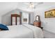 Spacious bedroom with light walls, complemented by wooden furniture and a window with curtains at 2570 Sweet Bay Rd, Rocky Mount, NC 27804