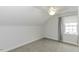 Well-lit bedroom featuring neutral walls, plush carpet, and a window at 2570 Sweet Bay Rd, Rocky Mount, NC 27804