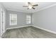 Grey bedroom with hard surface floors, ceiling fan, and bright natural light at 2570 Sweet Bay Rd, Rocky Mount, NC 27804