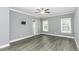 Grey bedroom with hard surface floors, ceiling fan, and bright natural light at 2570 Sweet Bay Rd, Rocky Mount, NC 27804