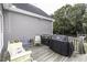 Outdoor deck with chairs, table, and grill with gray siding, great for entertaining at 2570 Sweet Bay Rd, Rocky Mount, NC 27804