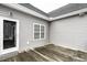 An exterior shot of the home's wooden deck, siding, door leading indoors, and window at 2570 Sweet Bay Rd, Rocky Mount, NC 27804