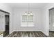 Bright dining area featuring a pendant light fixture and wood-look flooring at 2570 Sweet Bay Rd, Rocky Mount, NC 27804