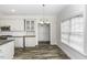 Bright dining area showcasing natural light, modern pendant, and wood-look floors at 2570 Sweet Bay Rd, Rocky Mount, NC 27804