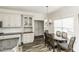 Cozy dining area featuring a round wood table, seating for four, and natural light from the window at 2570 Sweet Bay Rd, Rocky Mount, NC 27804