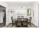 Dining area with wood flooring, dining table with seating, decorative butterflies, and natural light from the window at 2570 Sweet Bay Rd, Rocky Mount, NC 27804