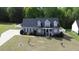 Beautiful two-story home featuring dormer windows and a well-manicured lawn with mature trees at 2570 Sweet Bay Rd, Rocky Mount, NC 27804