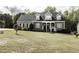 Inviting two-story home with manicured lawn and lush greenery, featuring dormer windows at 2570 Sweet Bay Rd, Rocky Mount, NC 27804