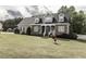 Two-story traditional home featuring stone accents, dormer windows, and manicured lawn at 2570 Sweet Bay Rd, Rocky Mount, NC 27804