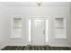 Bright entryway with wood-look floors, a classic white front door, and sidelight windows at 2570 Sweet Bay Rd, Rocky Mount, NC 27804