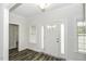 Welcoming foyer featuring wood-look floors, a classic white front door, and sidelight windows at 2570 Sweet Bay Rd, Rocky Mount, NC 27804