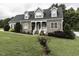 Charming two-story home with stone accents, dormers, and a welcoming front porch at 2570 Sweet Bay Rd, Rocky Mount, NC 27804