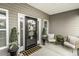 Welcoming front porch with chairs, plants, and decorative door at 2570 Sweet Bay Rd, Rocky Mount, NC 27804