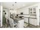 Modern kitchen features an island with seating, stainless steel appliances, and white cabinetry at 2570 Sweet Bay Rd, Rocky Mount, NC 27804