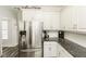 Bright kitchen with stainless steel refrigerator, granite countertops, and stylish backsplash at 2570 Sweet Bay Rd, Rocky Mount, NC 27804