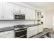 A kitchen with white cabinets, granite countertops, stainless steel appliances, and tile backsplash at 2570 Sweet Bay Rd, Rocky Mount, NC 27804