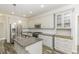 Open kitchen features granite countertops, stainless appliances, white cabinets, and tile backsplash at 2570 Sweet Bay Rd, Rocky Mount, NC 27804