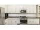 Updated kitchen featuring granite counters, stainless appliances, and ample storage space at 2570 Sweet Bay Rd, Rocky Mount, NC 27804