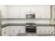 Updated kitchen with white cabinets, granite countertops, and stainless steel appliances at 2570 Sweet Bay Rd, Rocky Mount, NC 27804