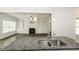 Granite countertop island with stainless steel faucet; looks out to living room with fireplace and built-in shelving at 2570 Sweet Bay Rd, Rocky Mount, NC 27804