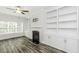 Bright living room features a fireplace, built-in bookshelves, and wood-look floors at 2570 Sweet Bay Rd, Rocky Mount, NC 27804