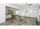 Spacious open-concept living area with wood-look floors, a fireplace, and backyard access at 2570 Sweet Bay Rd, Rocky Mount, NC 27804