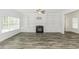Expansive living room showcasing wood-look floors, a fireplace, and built-in shelving at 2570 Sweet Bay Rd, Rocky Mount, NC 27804