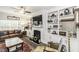Open-concept living room featuring a fireplace, built-in shelving, and lots of natural light at 2570 Sweet Bay Rd, Rocky Mount, NC 27804