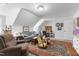 Comfortable living room with various seating options, a patterned rug, and slanted ceilings at 2570 Sweet Bay Rd, Rocky Mount, NC 27804