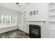 Cozy living room featuring wood-look floors, a fireplace, and built-in shelves at 2570 Sweet Bay Rd, Rocky Mount, NC 27804