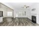 Open living area with wood-look floors, a fireplace, built-in shelves, and backyard access at 2570 Sweet Bay Rd, Rocky Mount, NC 27804