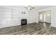 Bright living room features a fireplace, built-in bookshelves, and wood-look floors at 2570 Sweet Bay Rd, Rocky Mount, NC 27804