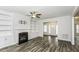 Bright living room features a fireplace, built-in bookshelves, and wood-look floors at 2570 Sweet Bay Rd, Rocky Mount, NC 27804