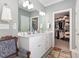 This spacious main bathroom features a double vanity and a doorway into the walk-in closet at 2570 Sweet Bay Rd, Rocky Mount, NC 27804