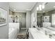 This main bathroom has a white tub, shower, and vanity with ample space for two at 2570 Sweet Bay Rd, Rocky Mount, NC 27804
