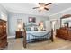 This spacious main bedroom has an elegant iron bed frame and a lovely ensuite at 2570 Sweet Bay Rd, Rocky Mount, NC 27804