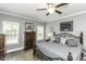This spacious main bedroom has gray walls, wood-look flooring, and windows letting in plenty of natural light at 2570 Sweet Bay Rd, Rocky Mount, NC 27804